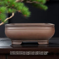 Rounded square brown bowl pot with low block feet and size labels