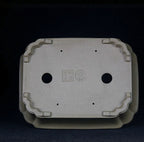 Underside of taupe rounded rectangular pot showing two large openings and four small holes