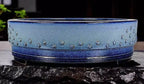 Close side view of the blue drum pot's studs and dark lower band