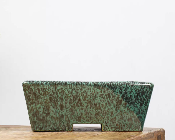 Side view of green and brown mottled rectangular bonsai pot