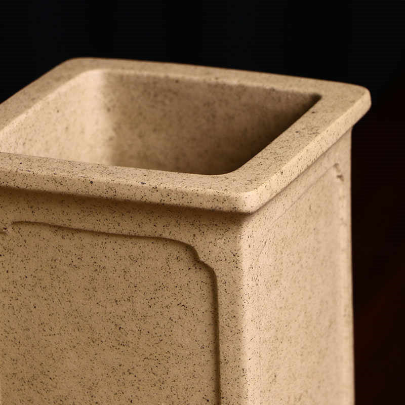 Close-up of tall tan pot showing speckled surface, square rim and interior