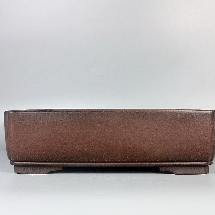 Plain reddish-brown rectangular pot with low feet and narrow lower band