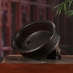 Dark-brown oval bonsai pot, tilted interior view
