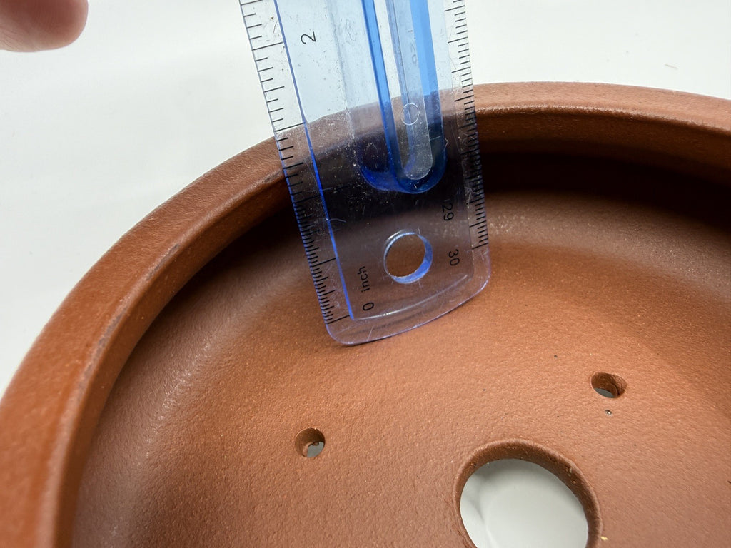 Ruler inside the brown pot demonstrating its usable depth