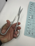 Hand-held view of the silver bonsai scissors with blades open