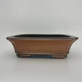 Brown rectangular bonsai pot with flared sides, clipped corners and low sculpted feet