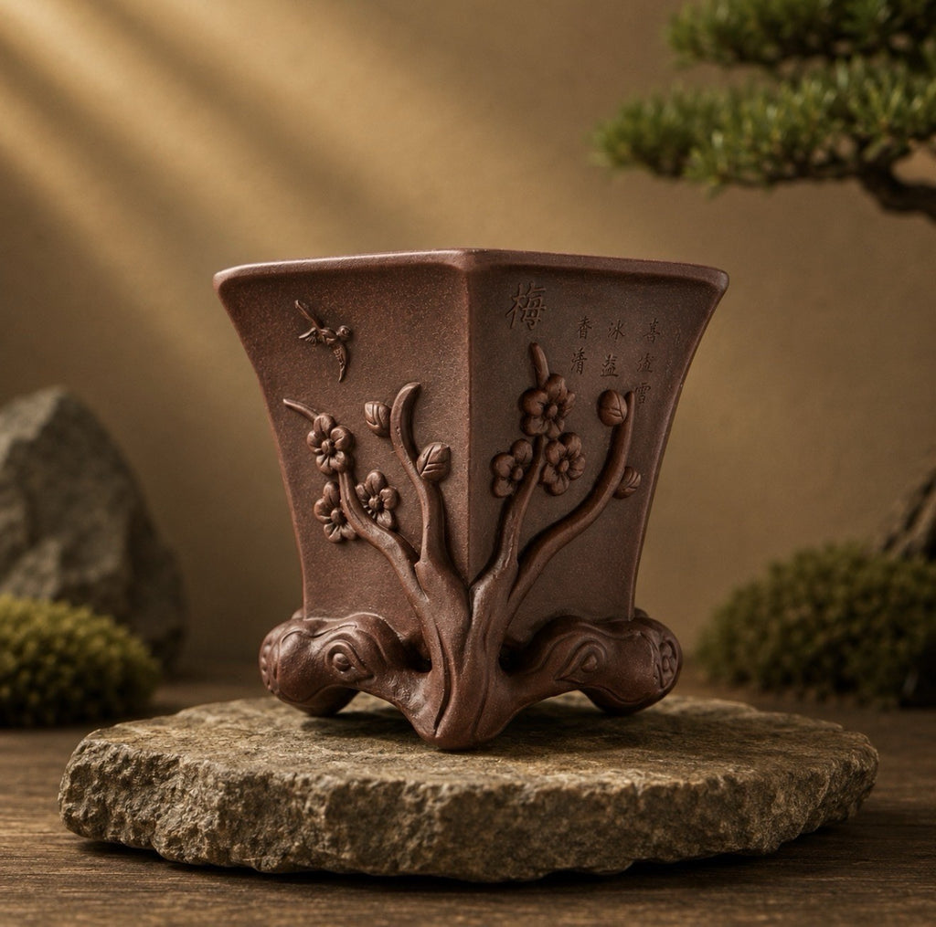 Tall brown hexagonal pot with flowering-branch relief displayed on a round stone slab