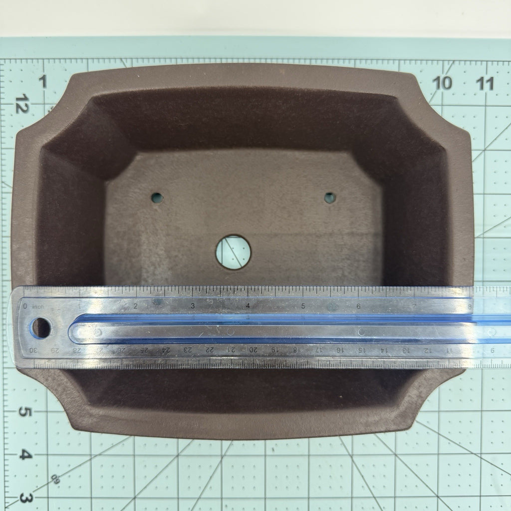 Ruler across the length of the dark rectangular pot's interior opening