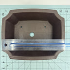 Ruler across the length of the dark rectangular pot's interior opening