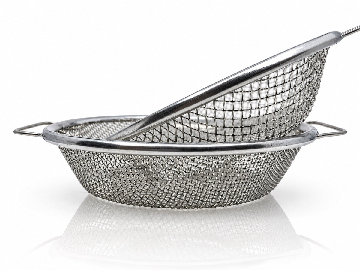 Two round metal soil sieves with different mesh sizes and side handles, nested at an angle
