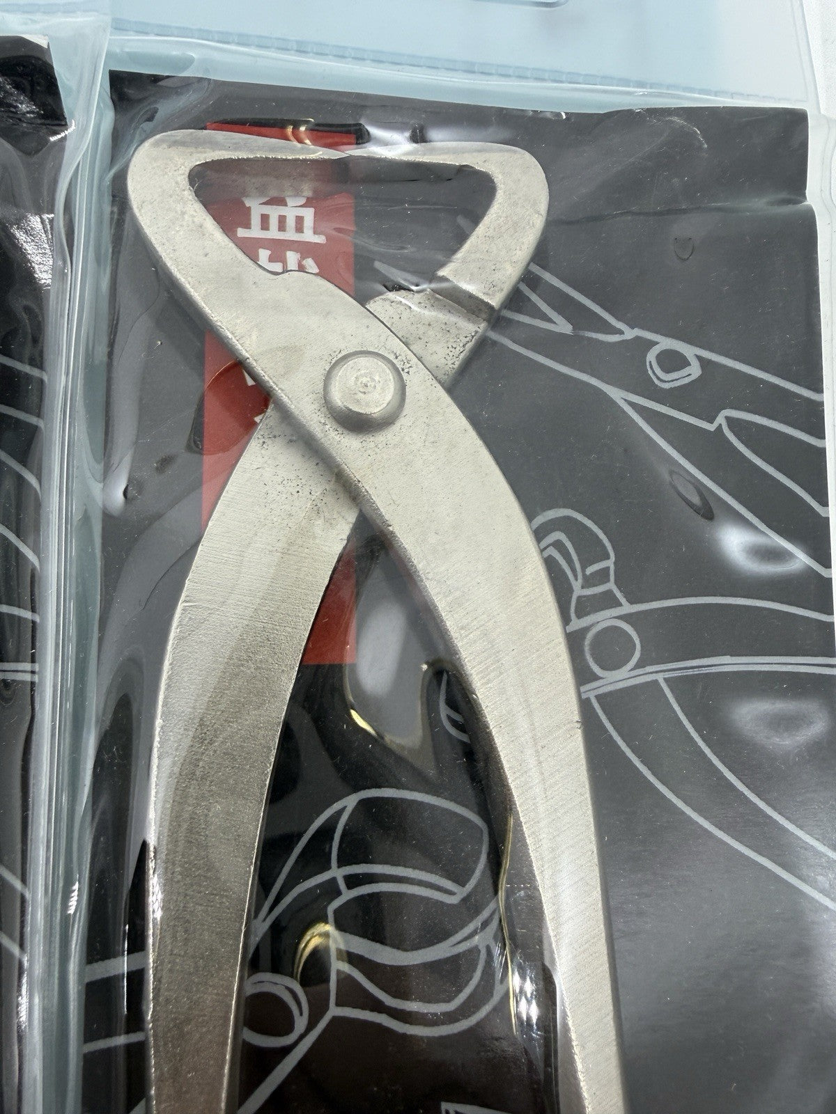 Close-up of a packaged bonsai cutter with broad end-cutting jaws