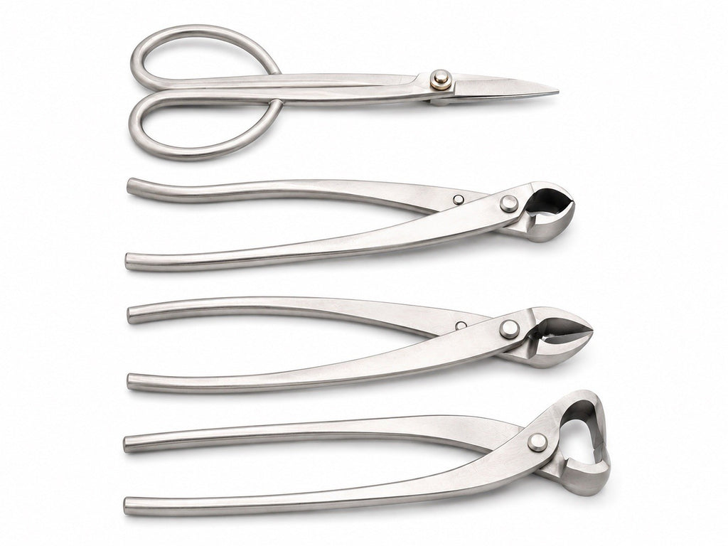 Four silver-colored bonsai tools arranged on white: scissors and three long-handled cutters