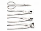 Four silver-colored bonsai tools arranged on white: scissors and three long-handled cutters