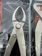 Close-up of a packaged bonsai cutter with pointed curved jaws