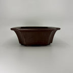 Low front view of the dark brown rectangular pot with outward-flaring sides