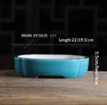 Turquoise oval bonsai pot with a pale interior and low feet, with measurement labels