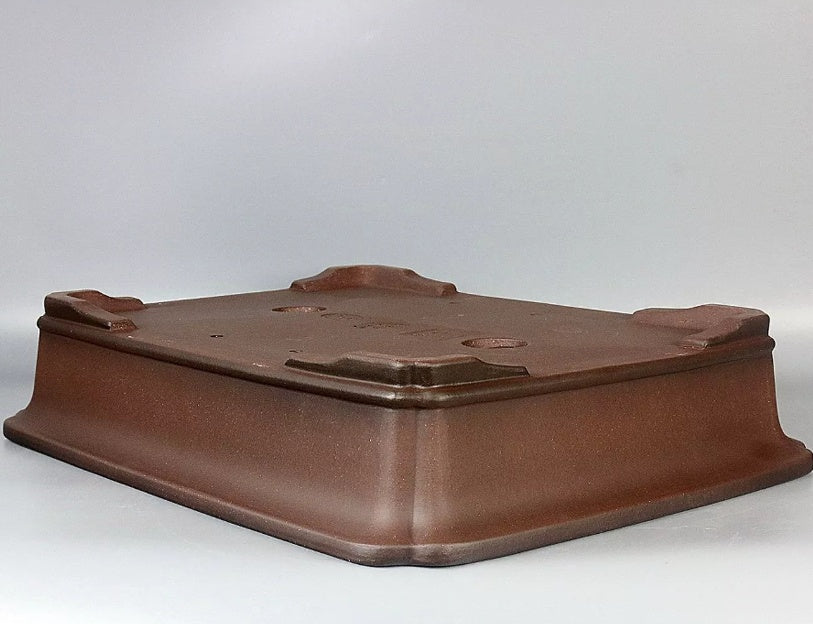 Brown rectangular bonsai pot underside, angled view