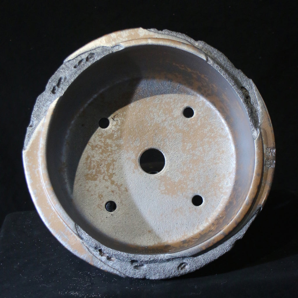 Top view of round pot showing central opening and four small holes