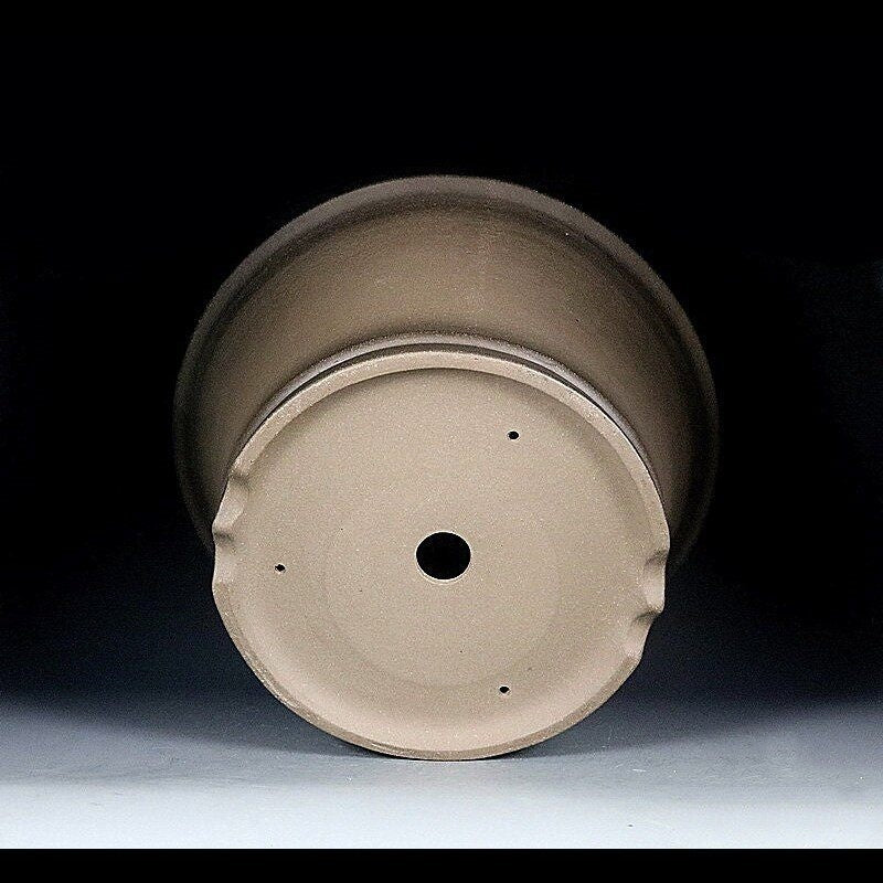 Underside angle of the taupe pot showing central drainage and small holes