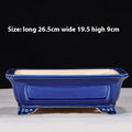 Blue rectangular bonsai pot with recessed side panels and curled feet, with dimensions above