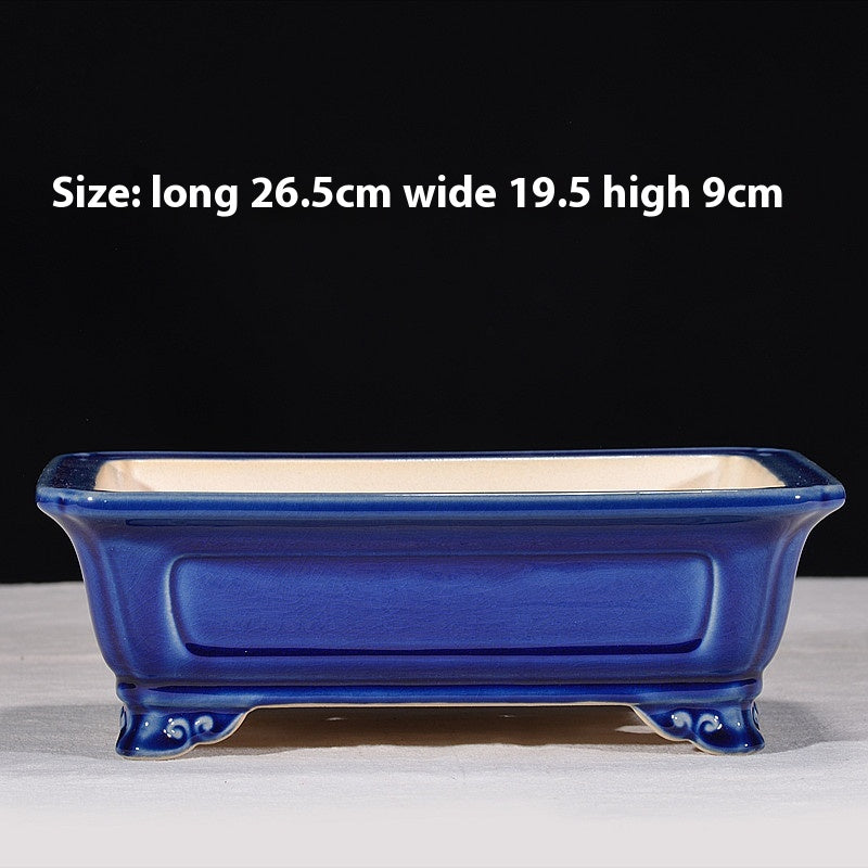 Blue rectangular bonsai pot with recessed side panels and curled feet, with dimensions above