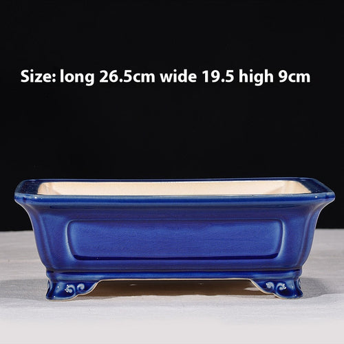 Blue rectangular bonsai pot with recessed side panels and curled feet, with dimensions above