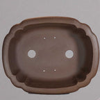 Top view of brown lobed pot showing two large openings and four small holes