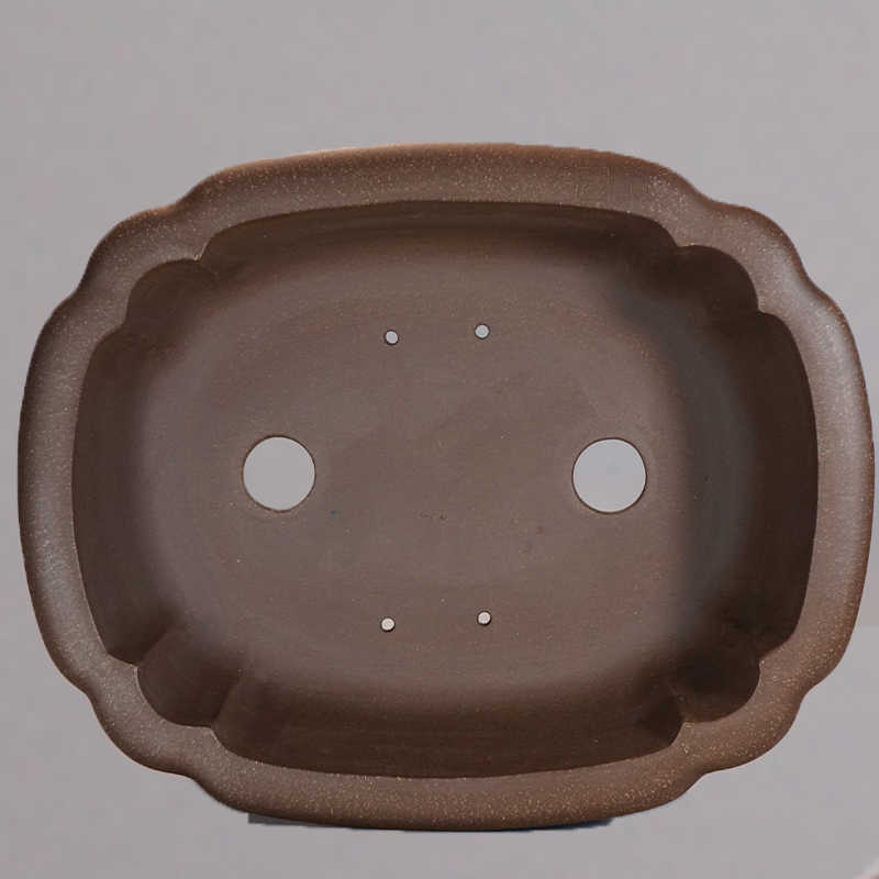 Top view of brown lobed pot showing two large openings and four small holes