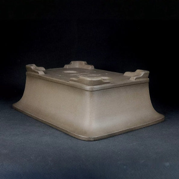 Taupe flared-wall pot upside down showing corner feet