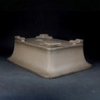Taupe flared-wall pot upside down showing corner feet