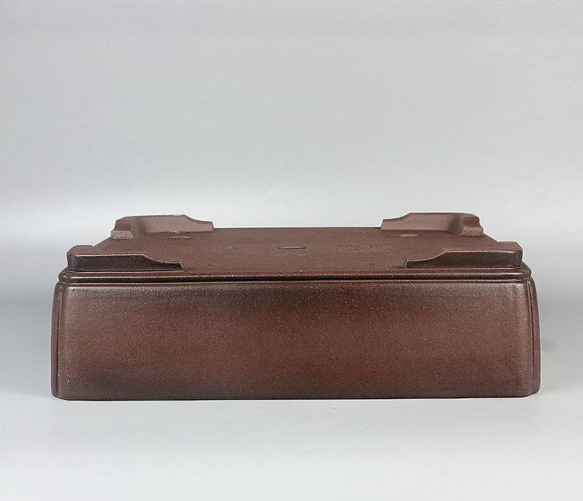 Brown rectangular pot upside down showing corner feet