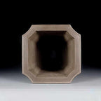 Top view of the tall taupe pot's clipped-corner opening