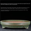 Green-glazed oval bonsai pot with a banded rim and decorative feet, with dimensions above
