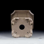 Underside of the tall square pot showing central drainage hole and corner feet