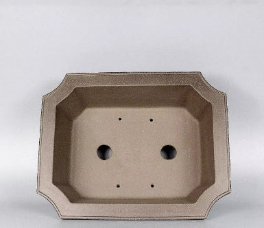 Interior of the clipped-corner rectangular pot showing drainage openings
