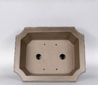 Interior of the clipped-corner rectangular pot showing drainage openings