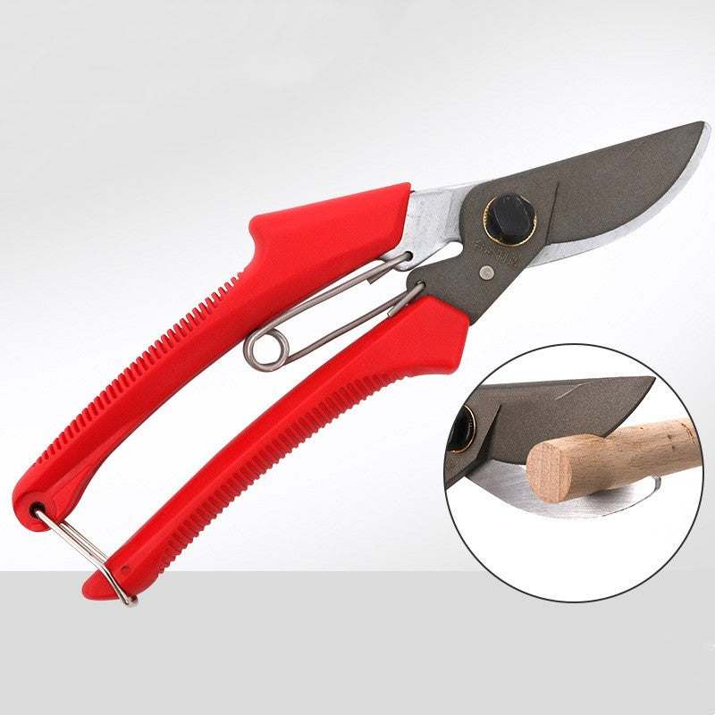 Red-handled bypass pruning shears with spring and inset showing a blade cutting wood