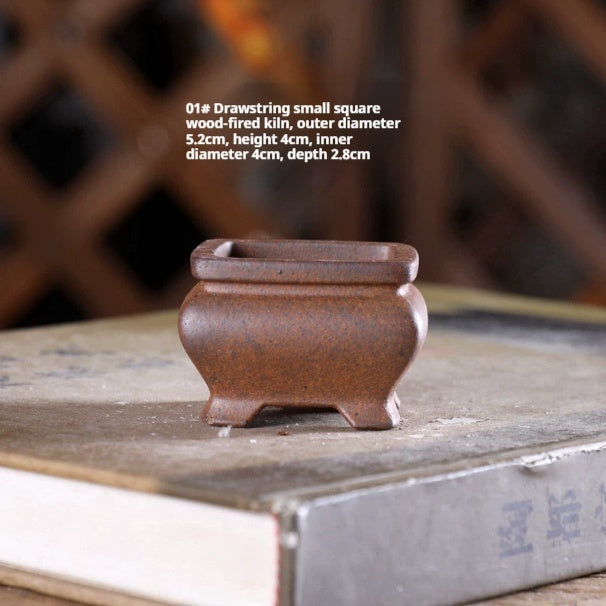 Small brown square bonsai pot with rounded shoulders, a flared rim and corner feet, with dimensions above