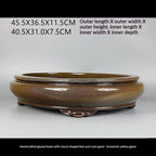 Angled brown-gold oval pot with exterior and interior measurement labels