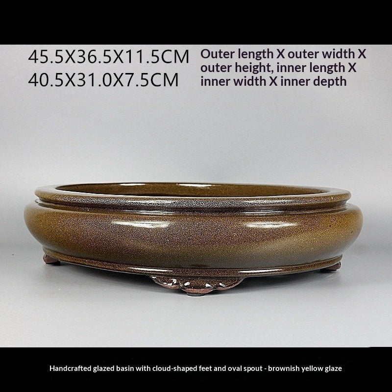 Angled brown-gold oval pot with exterior and interior measurement labels