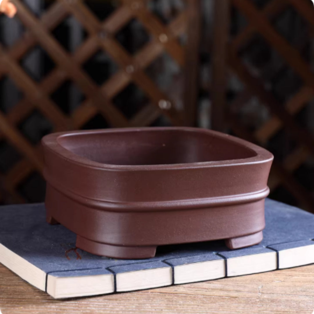 Angled view of brown rounded square pot showing interior