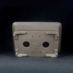 Underside of the taupe pot with two drainage holes and impressed marks