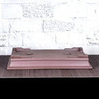 Side view of upside-down brown rectangular bonsai pot showing corner feet