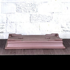 Upside-down brown rectangular pot showing low feet and flared base profile