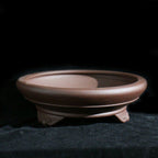 Brown round cloud-foot bonsai pot, angled view