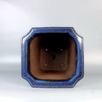 Top view of blue square pot showing brown interior and base openings