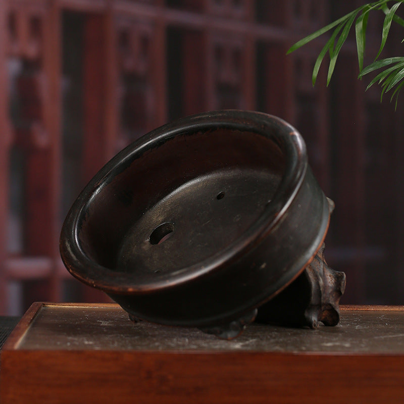 Dark-brown oval pot drainage and cloud-style feet