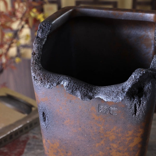 Close-up of the tall pot's rough irregular rim and dark interior