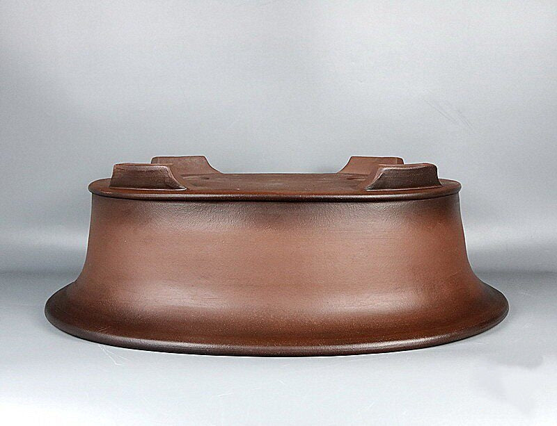Side profile of upside-down brown oval pot