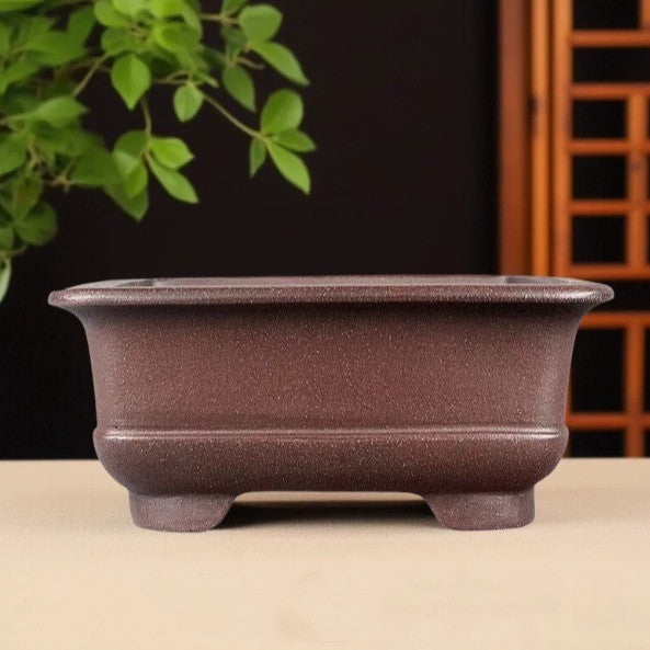 Brown square bonsai pot with flared rim and rounded lower corners